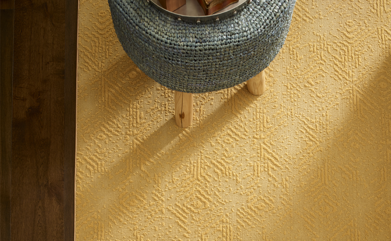 yellow textured carpet on hardwood flooring
